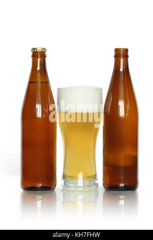 Glass of lager beer near two bottles isolated on white background with clipping path Stock Photo