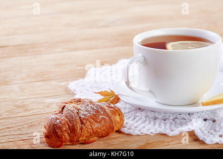 Homemade biscuits and a cup of tea on the table in the morning Stock Photo