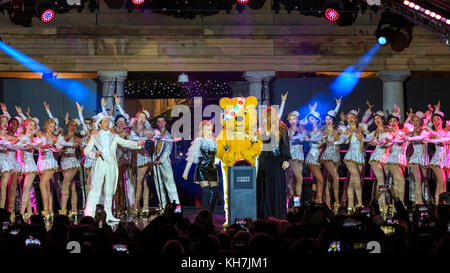 Covent Garden, London, UK, 14th Nov 2017. The Covent Garden Christmas lights 2017 are switched on by Pudsey with special guests, singer Kylie Minogue and designer Charlotte Tilbury. Festive celebrations include performances from the acclaimed hit West End musical 42nd Street performing numbers from the show. Pudsey and his special guests Kylie switch on the lights in collaboration with BBC Children in Need this year. The Piazza hosts London’s biggest hand-picked Christmas tree. Credit: Imageplotter News and Sports/Alamy Live News Stock Photo