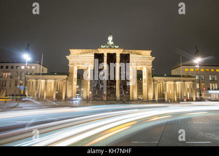 Three vertically placed discarded buses, standing in front of the Brandenburg Gate in Berlin, Germany, 14 November 2017. The installation 'Monument' by German-Syrian artist Manaf Halbouni is meant to conmemorate the Syrian civil war. Halbouni was inspired by a barricade that was erected in Aleppo to provide cover from snipers. Photo: Stefan Jaitner/dpa Stock Photo