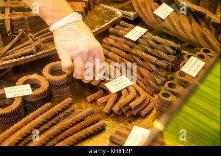 A server picking up a piece of shaped chocolate cast into the shape of an Allen key, Toulouse, Occitanie, France Stock Photo