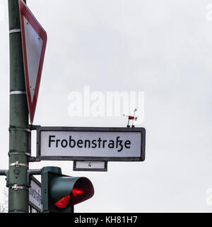 Berlin-Schöneberg-Tempelhof district. Kork Yogi, cork yogi miniature man doing yoga on Frobenstrasse street sign Stock Photo