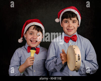 children singing Christmas carols at Christmas Stock Photo