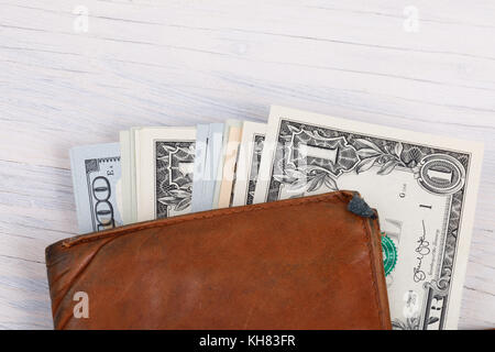 leather wallet with money banknotes USA dollars on wooden background Stock Photo