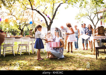 Family celebration or a garden party outside in the backyard. Stock Photo