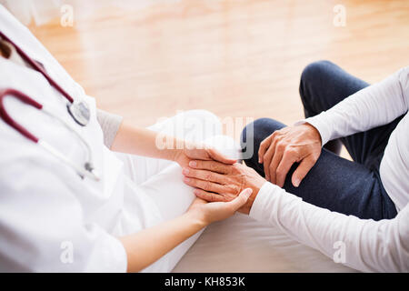 Health visitor and a senior man during home visit. Stock Photo