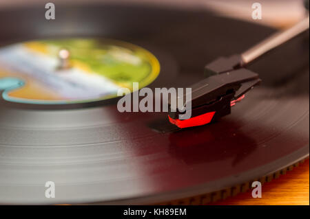 Vinyl record album playing on a record player, turntable. Stock Photo
