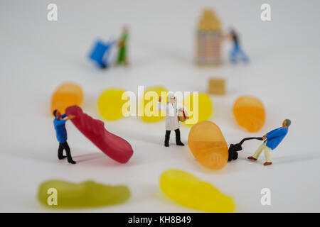 Miniature of storemans standing in front ofcandys model and small figures. Stock Photo