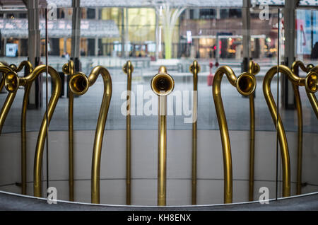 Twenty-three trumpets acoustically connect two floors of a modern building in Porta Nuova, Milan Stock Photo