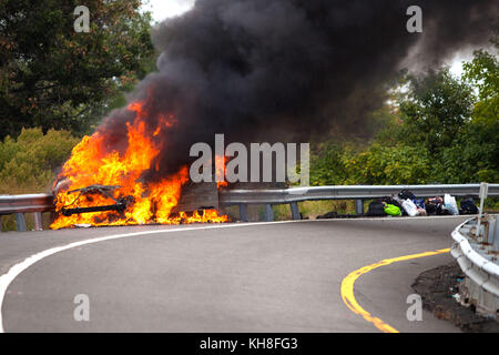 Car on fire with passengers on highway Stock Photo - Alamy