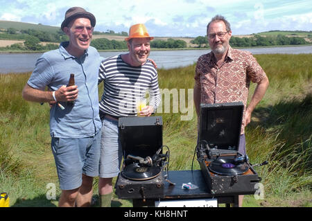 Three men wo play old 78 gramophone records. Stock Photo