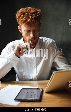 photo of attractive bearded man reading newspaper Stock Photo - Alamy