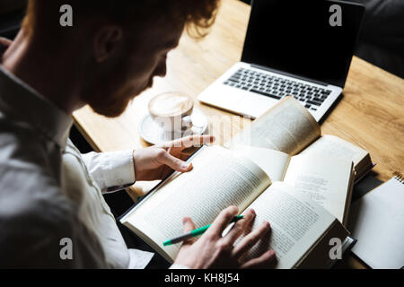 Top view of young readhead male student preparing for university exam Stock Photo