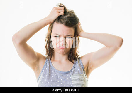 A young brown haired  caucasian teenage girl wearing pyjams looking tired sleepy  exhausted ready for bed, overtired, stressed, grumpy, moody, Stock Photo