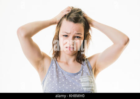 A young brown haired  caucasian teenage girl wearing pyjams looking tired sleepy  exhausted ready for bed, overtired, stressed, Stock Photo