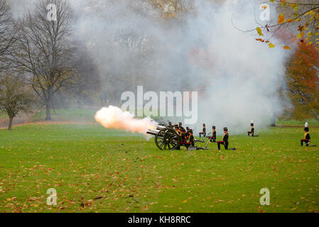 King's Troop Royal Horse Artillery firing a 41 gun salute for Prince of Wales 69th birthday in Green Park, London. Autumn colours Stock Photo