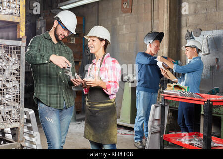 Metal construction operation with craftsmen working in cooperation Stock Photo