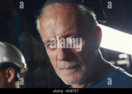 Senior man as craftsman with experience in metallurgy factory Stock Photo