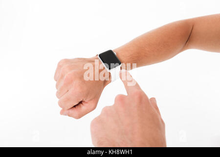 Close up portrait of a male hands pointing finger at blank screen smart watch isolated over white background Stock Photo