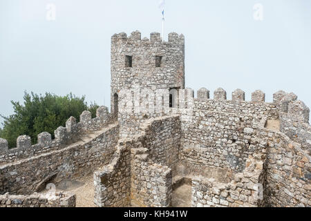 View of ruin Moorish Castle (Castelo dos Mouros) in fog. Sintra, Portugal Stock Photo