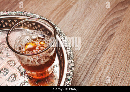 Close up of moroccan tea cup on a wooden table Stock Photo