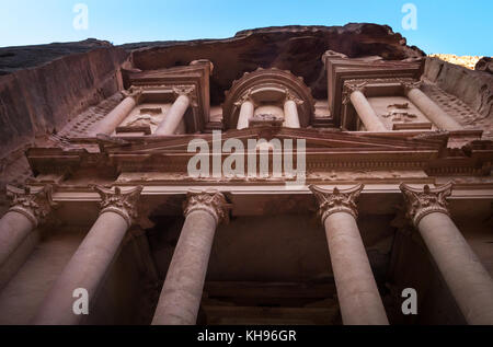 Looking up at Corinthian columns of ornate pink sandstone Nabataean Treasury, Al Khazneh, Petra, Jordan, Middle East, in early morning light Stock Photo
