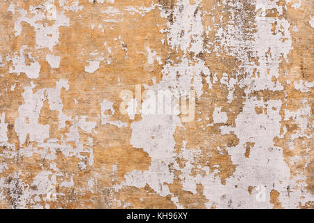 Chipped paint on old wall background - Old cement plastered wall that has chipped paint. Stock Photo