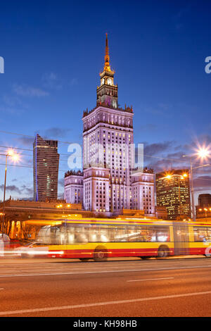Palace of Culture and Science at dusk in city downtown of Warsaw, Poland, Marszalkowska street in the foreground. Stock Photo