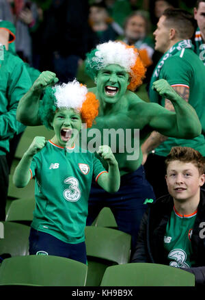 Republic of Ireland fans show support for their team in the stands before the FIFA World Cup qualifying play-off second leg match at the Aviva Stadium, Dublin. Stock Photo