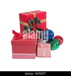 Three red gift boxes with colorful Christmas balls on white background. Stock Photo