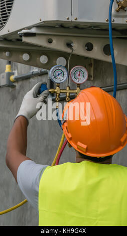 Technician is checking outdoor air conditioner unit Stock Photo