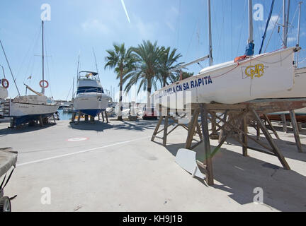 SA RAPITA, MALLORCA, BALEARIC ISLANDS, SPAIN - OCTOBER 6, 2017: Boats up for winter repair in the harbor on a sunny day on October 6, 2017 in Sa Rapit Stock Photo