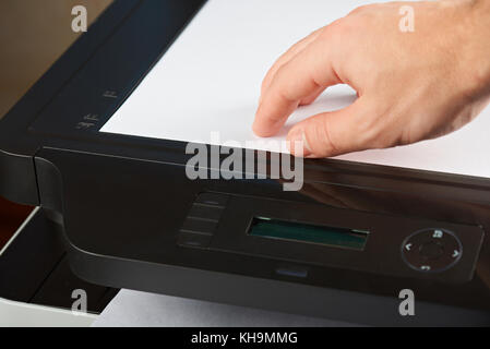 Scanning document concept close-up. Hand hold paper for scan Stock Photo