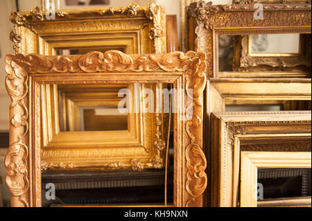 Collection of gilded classical large gold leaf empty picture frames ready to house a painting Stock Photo