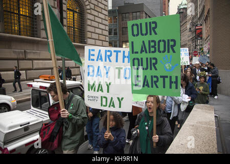Environmental activists rally on Earth Day at Zuccotti Park, then march to Wall Street calling for system change not climate change. The Occupy movement is still around in NYC it seems. Stock Photo
