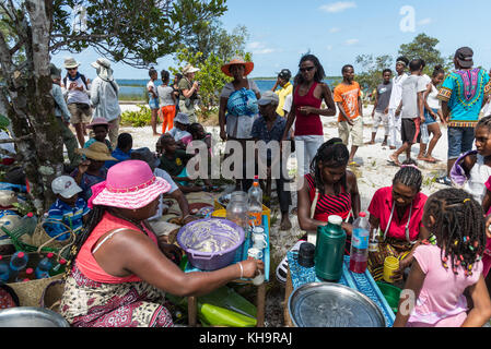 People gather around a food stall at a Zebu sacrifice ceremony, Lake Ampitabe, Toamasina, Madagascar, Africa Stock Photo