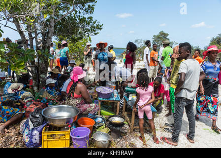 People gather around a food stall at a Zebu sacrifice ceremony, Lake Ampitabe, Toamasina, Madagascar, Africa Stock Photo
