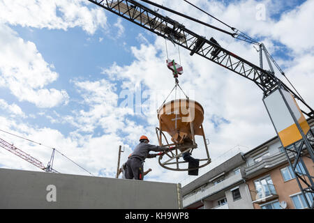Construction workers pouring concrete Stock Photo