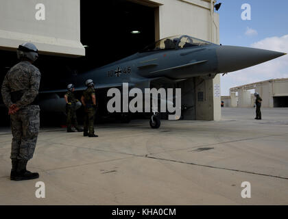 U.S. Air Force Senior Airman Cody Linholm, left, 510th Aircraft Maintenance Unit crew chief, watches two German air force crew chiefs prepare a German Stock Photo