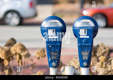 blue parking meters with no time on them in a city setting. Stock Photo
