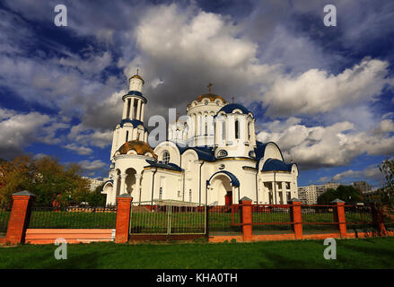 Golden domes of the Orthodox church in the background of the cloudy autumn sky Stock Photo