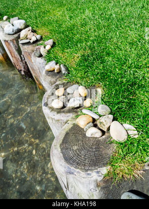 Elevated slanted view of a stone banked wooden bank attachment at Lake Kaltern Stock Photo
