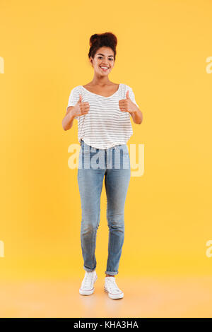 Happy afro-american lady with curly hair showing thumbs up and smiling isolated Stock Photo