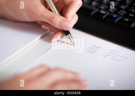 business woman hand writing on paper. Stock Photo