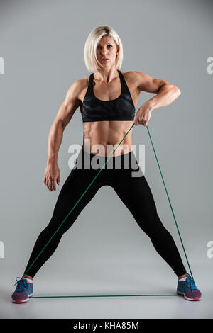 Concentrated athlete stretching resistance elastic band with hands