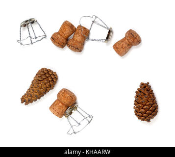 Fir cones and champagne wine corks with muselet. Isolated on white background. View from above. Stock Photo