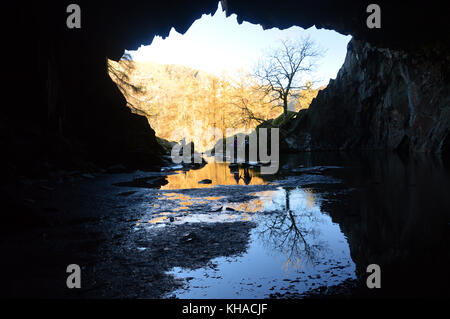 Fell Walkers in Rydal Cave above Rydal Water in the Lake District National Park, Cumbria, UK. Stock Photo