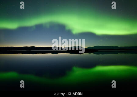Northern lights reflected in a lake in the Abisko National Park, Sweden Stock Photo