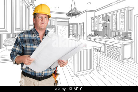 Male Contractor With House Plans Wearing Hard Hat In Front of Custom Kitchen Drawing Stock Photo
