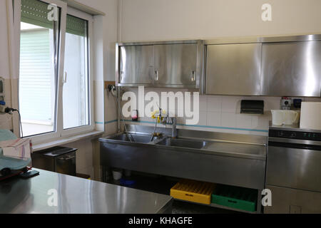 interior of an industrial kitchen with stainless steel sink Stock Photo